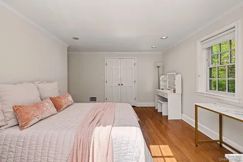 a bedroom with a bed and a large window