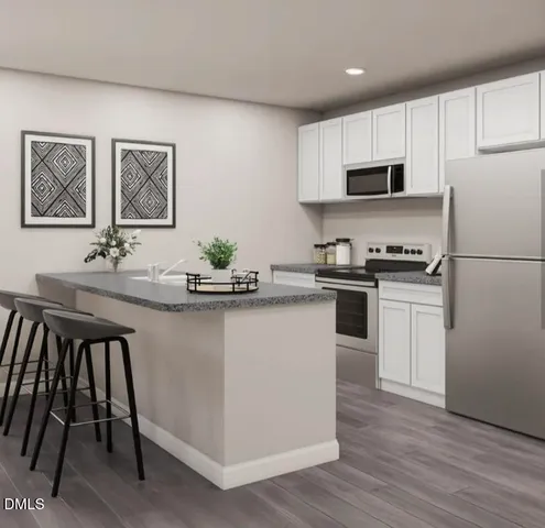 a kitchen with stainless steel appliances a sink and a refrigerator