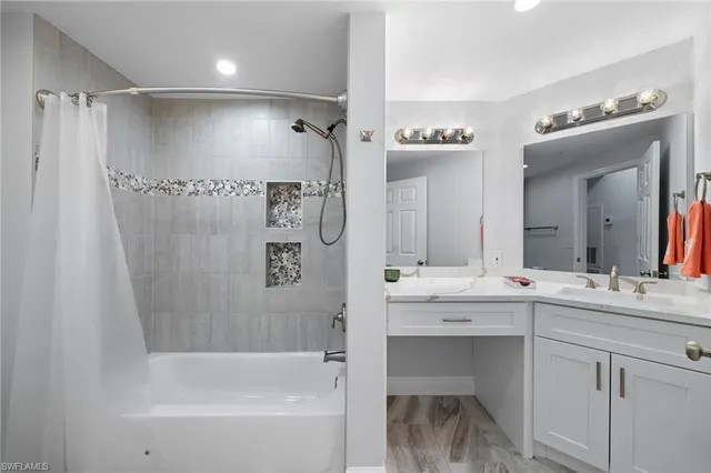 a bathroom with a bathtub sink vanity and mirror