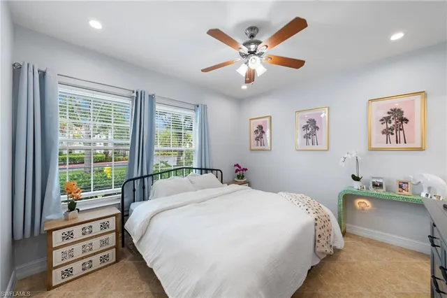 a bedroom with a bed and a large window