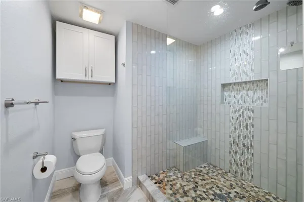 a bathroom with a toilet sink and shower
