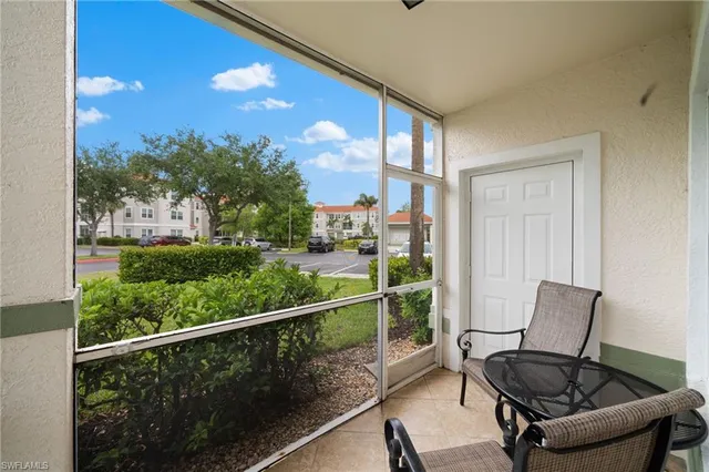 a view of a chair and table in the balcony