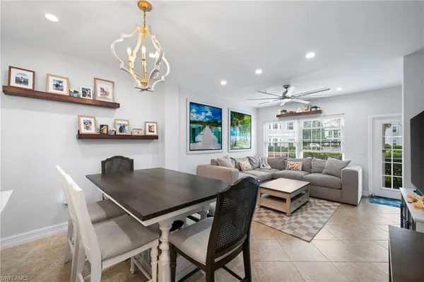 a view of a dining room with furniture a livingroom and chandelier