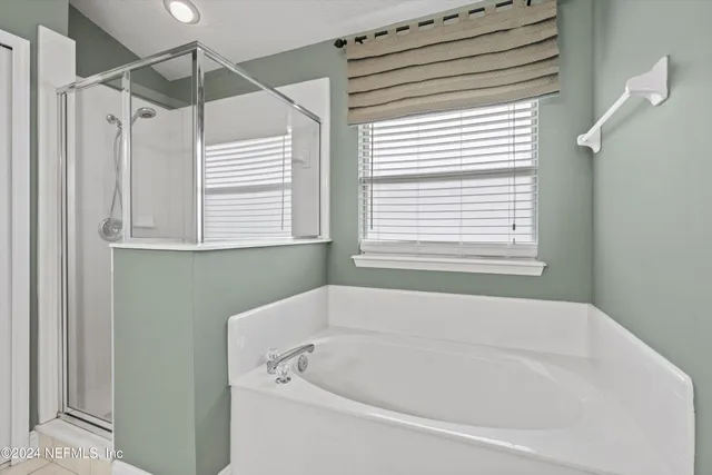 a white bath tub sitting next to a window