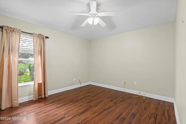 wooden floor in an empty room with a window