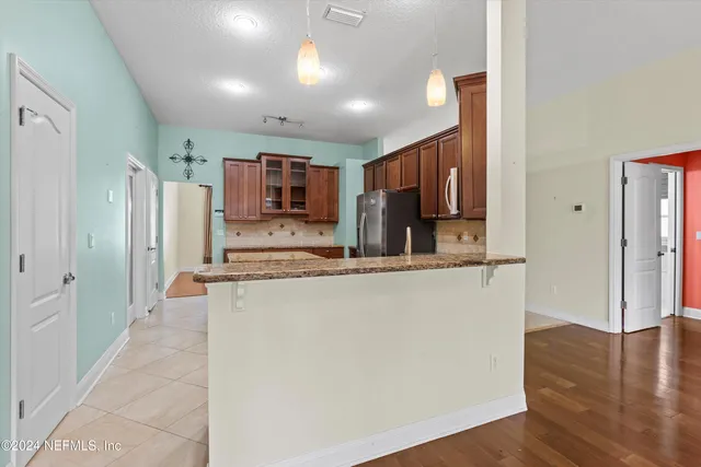 a kitchen with stainless steel appliances granite countertop a refrigerator and a sink