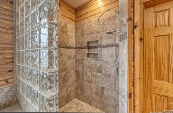 a bedroom with a large bed and a large window