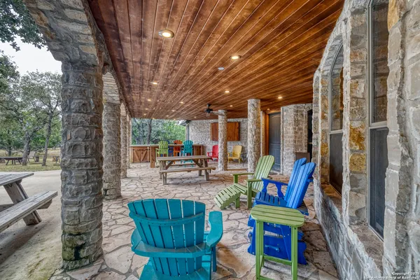a view of a porch with chairs and backyard
