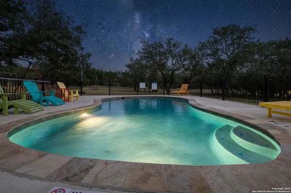 a view of a dining room with furniture wooden floor and chandelier
