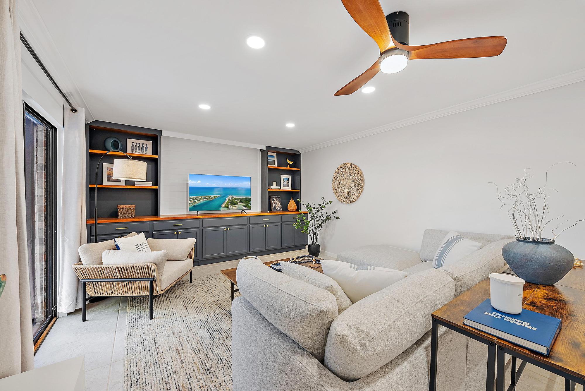 1420 Ocean Way, Unit 30C Jupiter, FL 33477 - Photo 11 of 25 a living room with furniture and a mirror