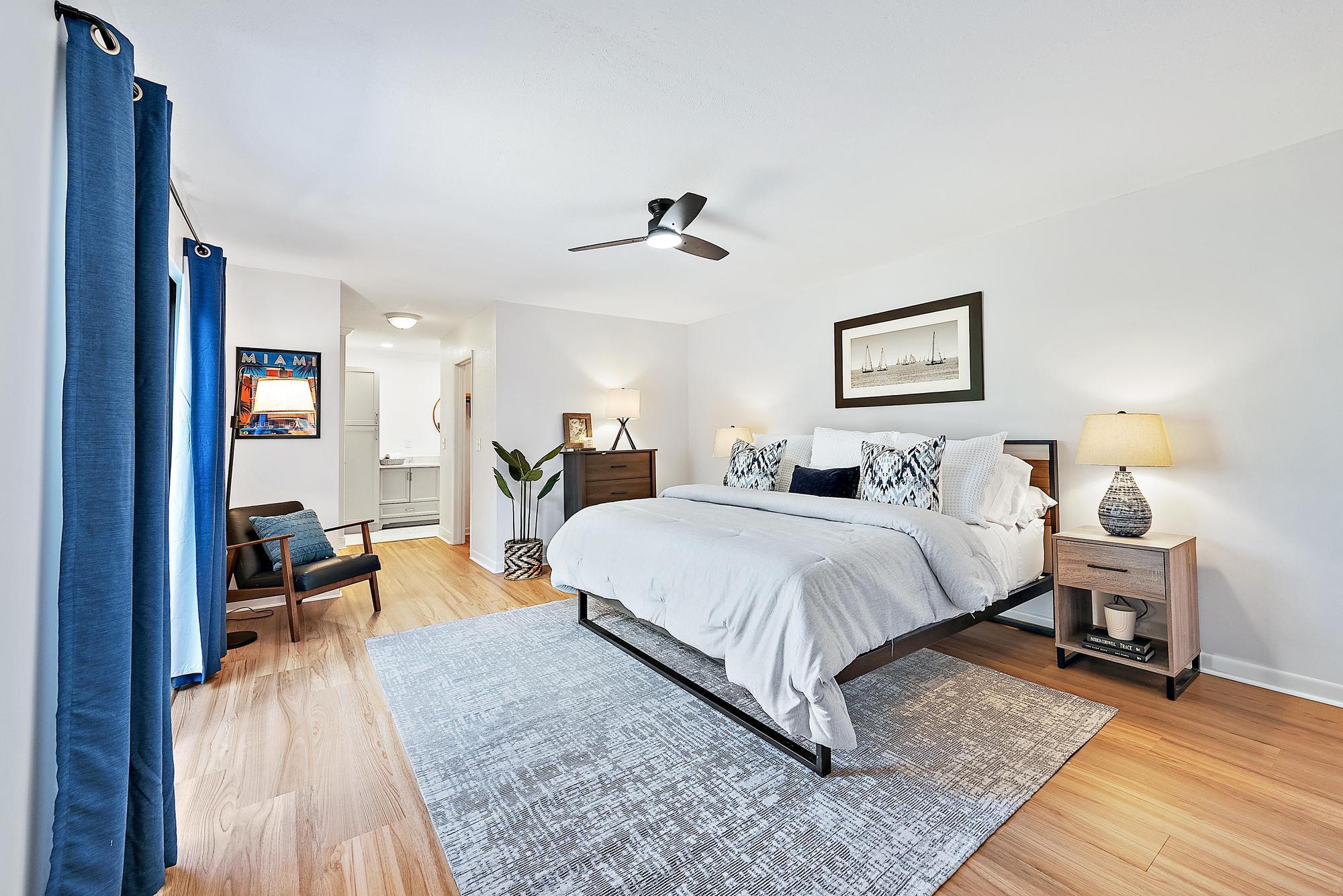 1420 Ocean Way, Unit 30C Jupiter, FL 33477 - Photo 13 of 25 a spacious bedroom with a bed a table and chair