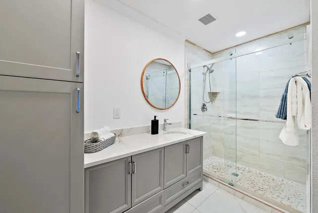 a bathroom with a sink a toilet and shower