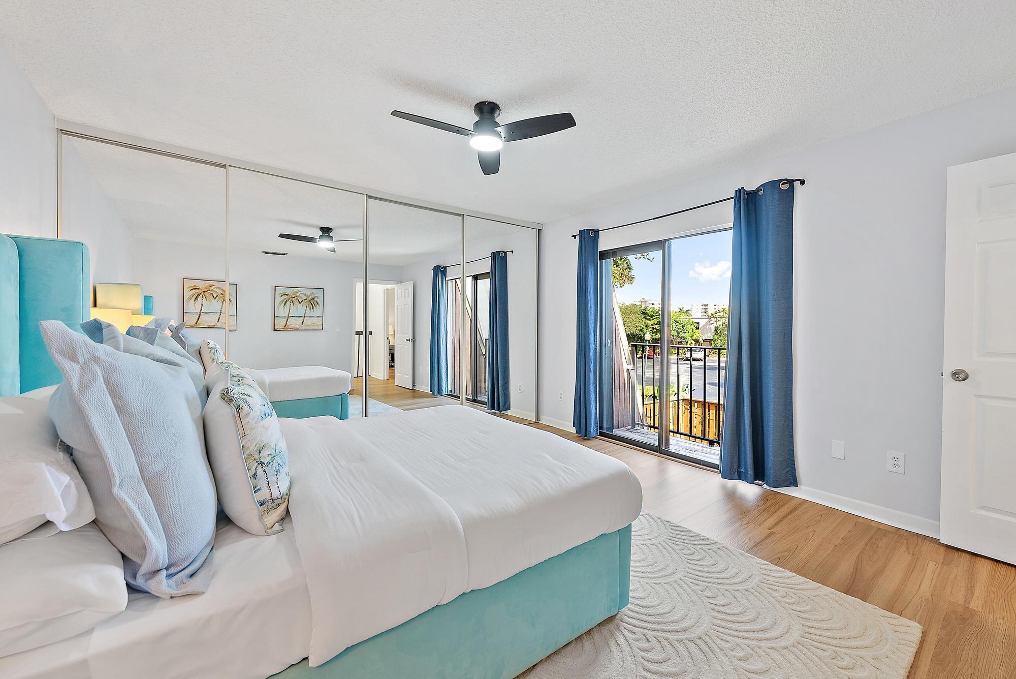 1420 Ocean Way, Unit 30C Jupiter, FL 33477 - Photo 17 of 25 a bed room with a bed and a large window