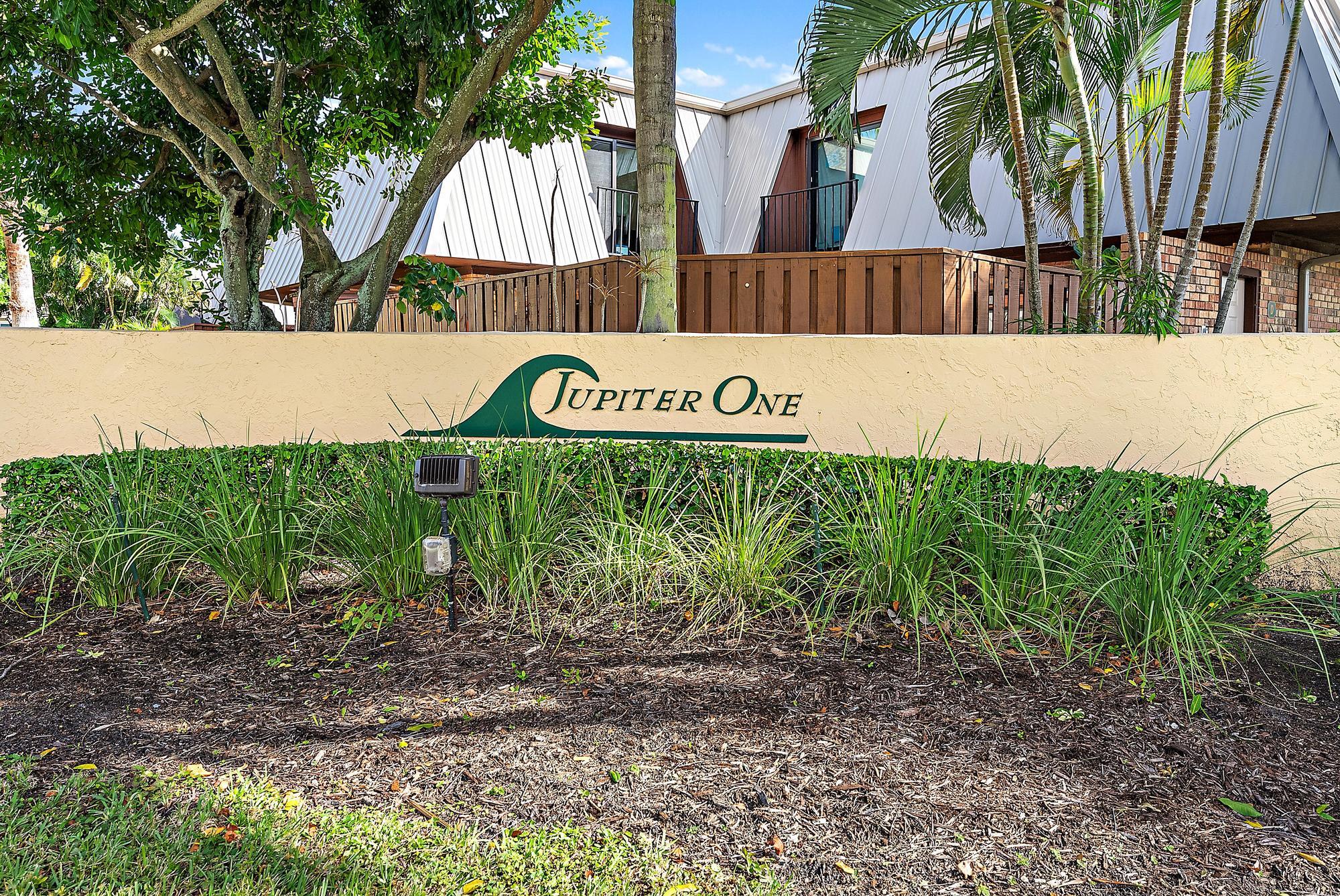 1420 Ocean Way, Unit 30C Jupiter, FL 33477 - Photo 20 of 25 a street sign that is on a blue wall