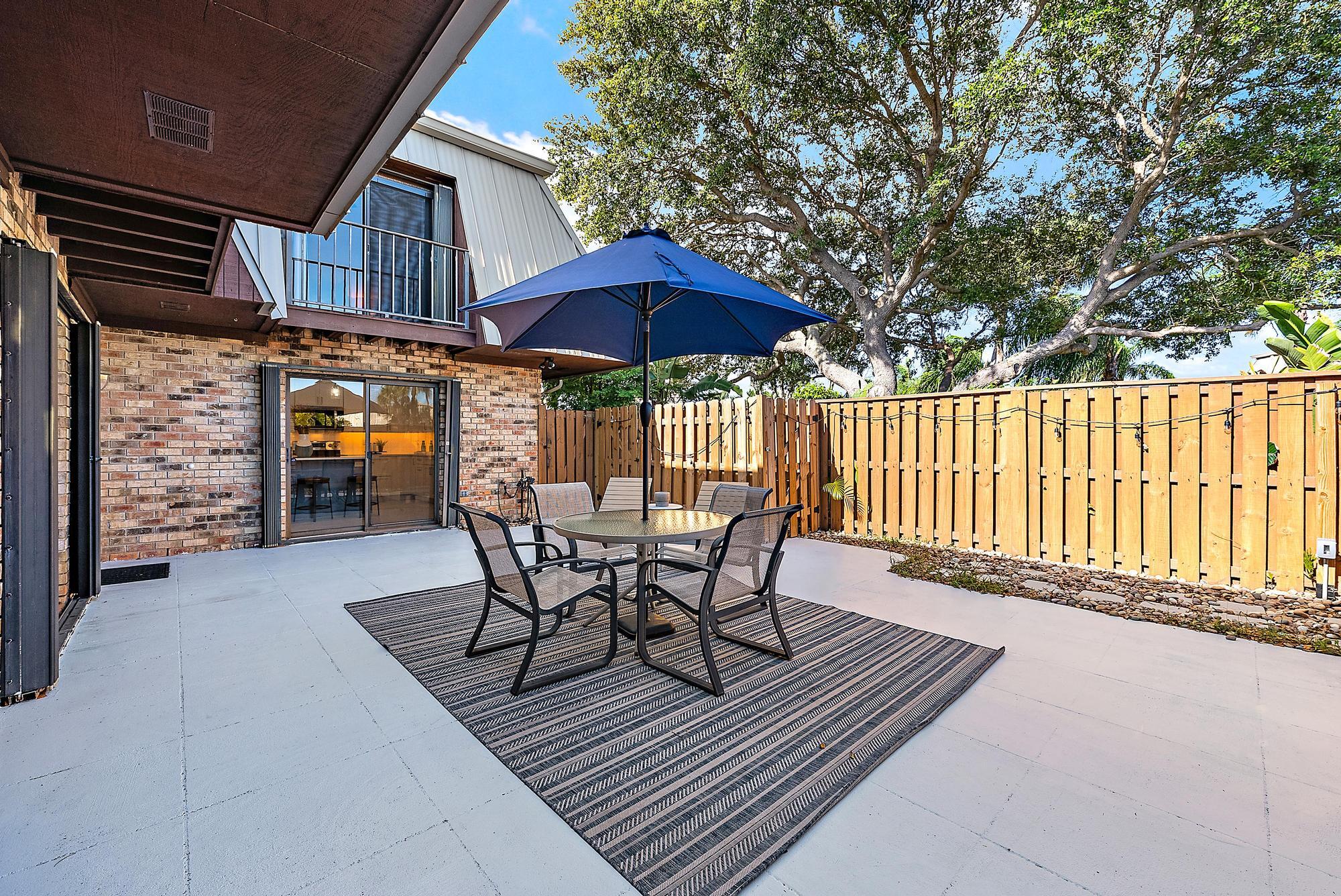 1420 Ocean Way, Unit 30C Jupiter, FL 33477 - Photo 5 of 25 a view of a chairs and table in the wooden roof deck