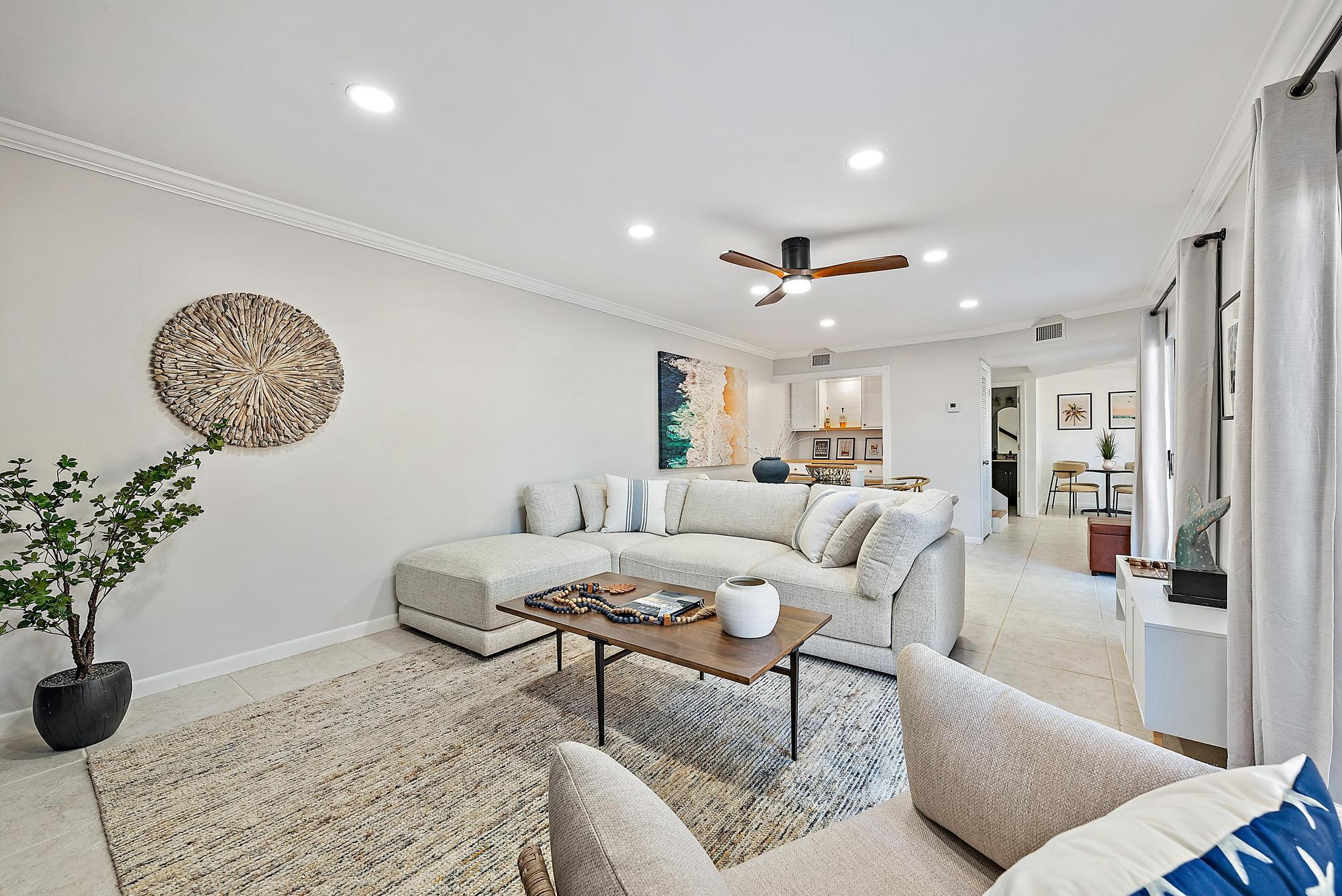 1420 Ocean Way, Unit 30C Jupiter, FL 33477 - Photo 9 of 25 a living room with furniture potted plant and a chandelier