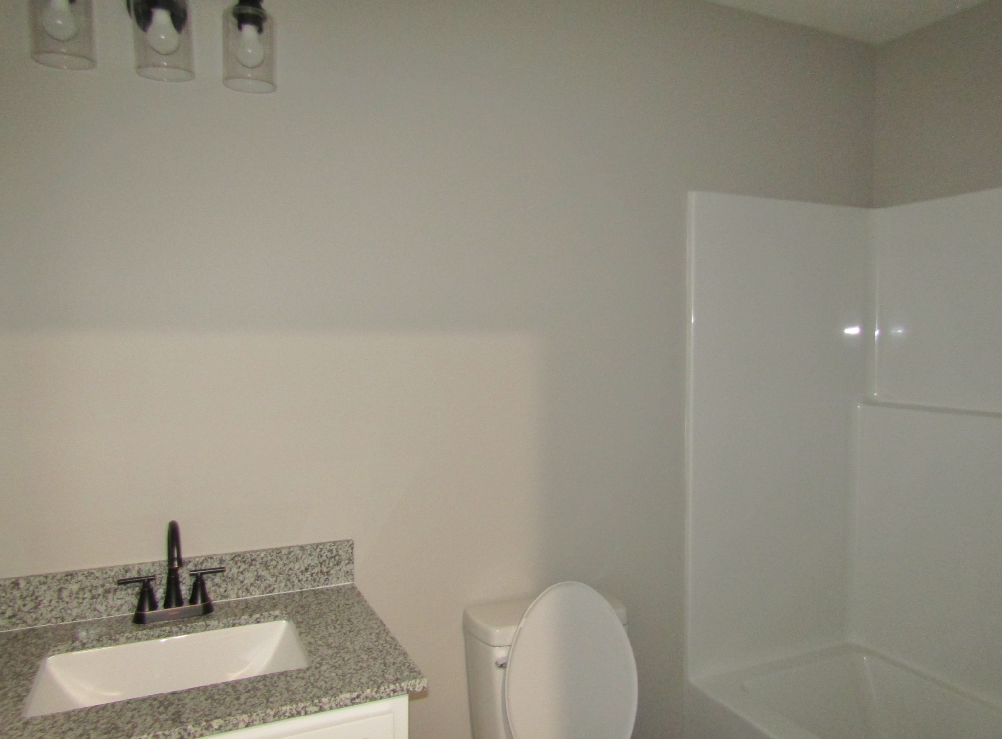 480 Crescent Factory Road Lawrenceburg, TN 38464 - Photo 13 of 14 a bathroom with a granite countertop sink a toilet and mirror
