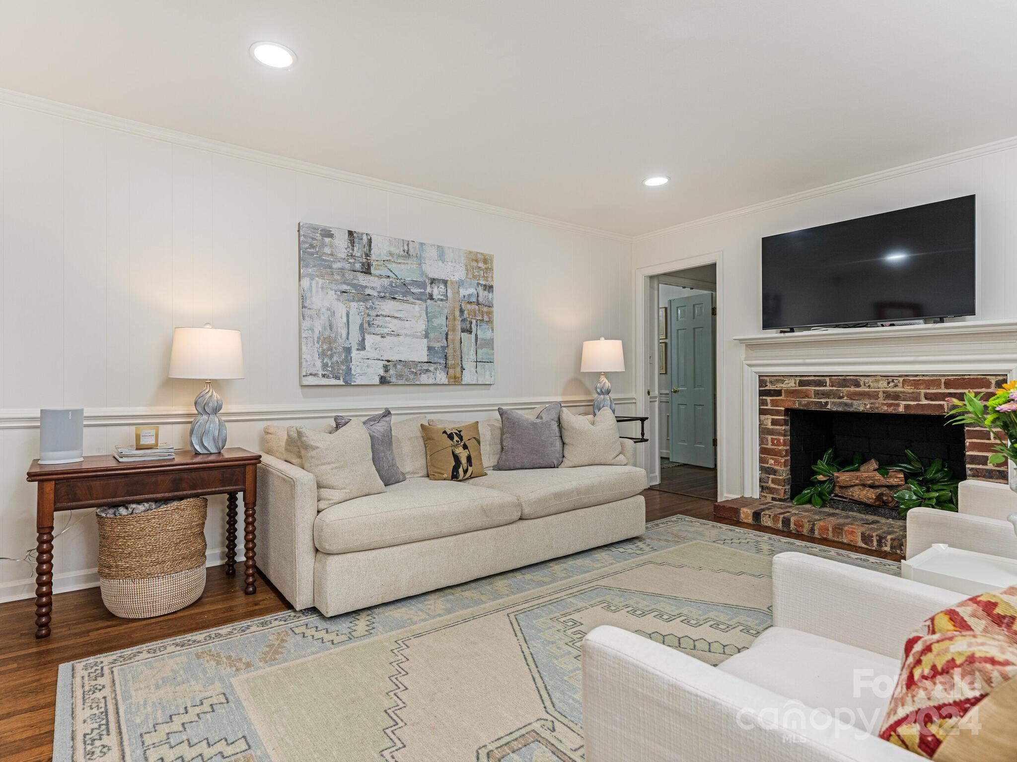 3912 Lovett Circle Charlotte, NC 28210 - Photo 12 of 25 a living room with furniture a flat screen tv and a fireplace