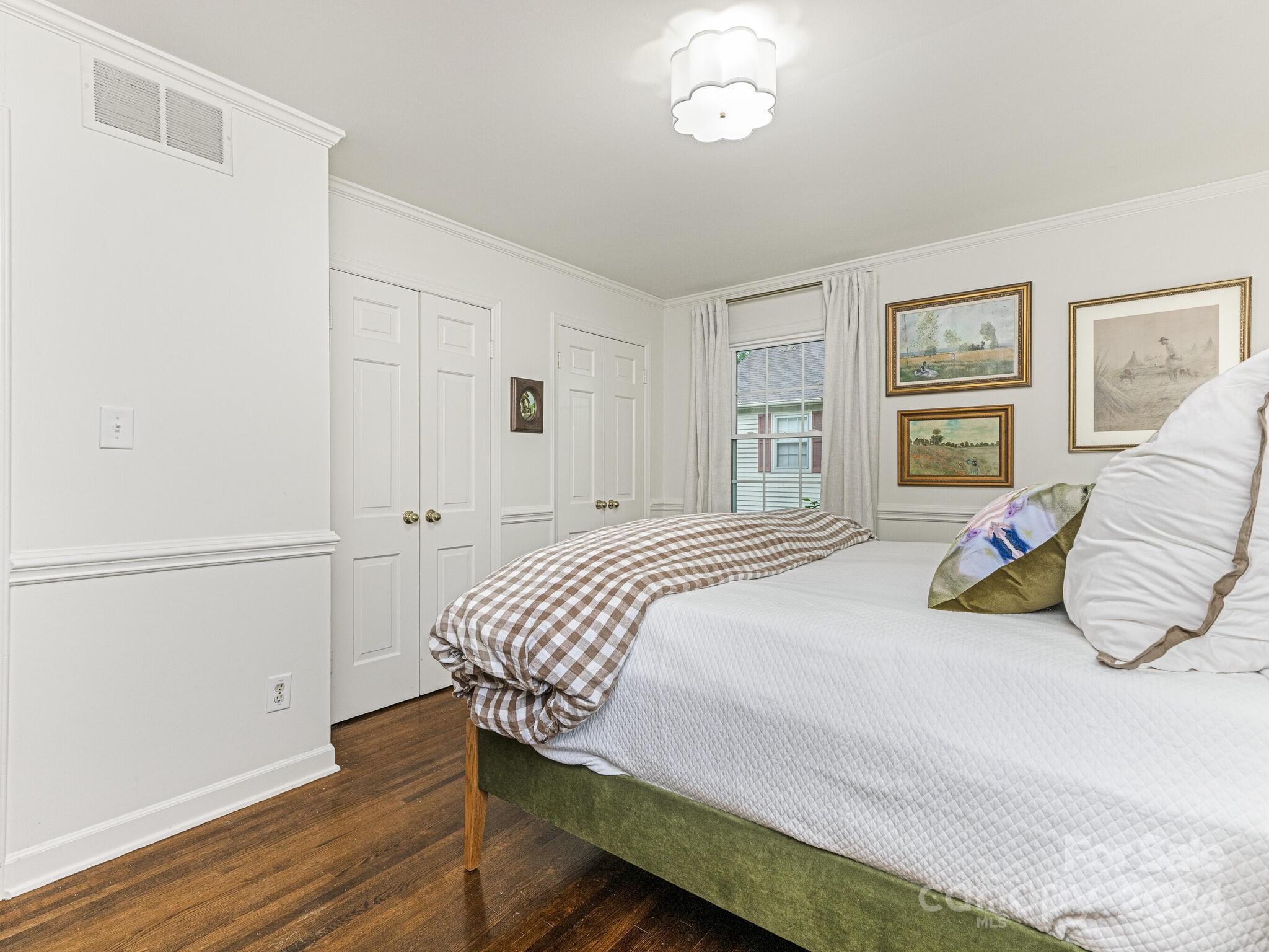 3912 Lovett Circle Charlotte, NC 28210 - Photo 16 of 25 a bedroom with a bed and wooden floor