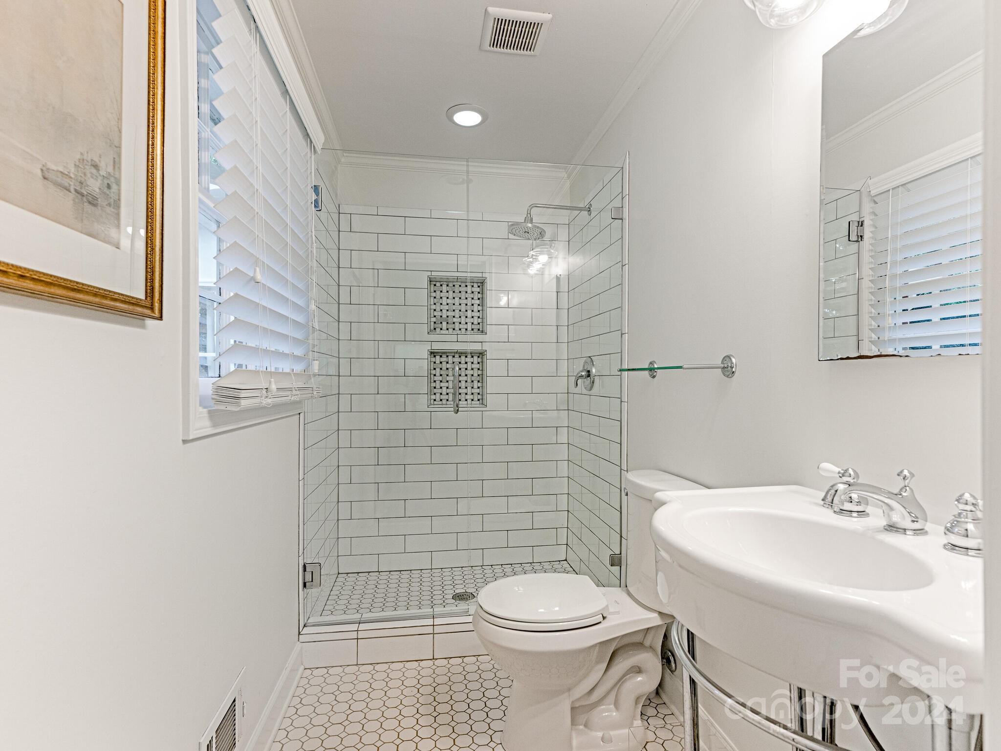 3912 Lovett Circle Charlotte, NC 28210 - Photo 17 of 25 a bathroom with a sink a toilet and shower