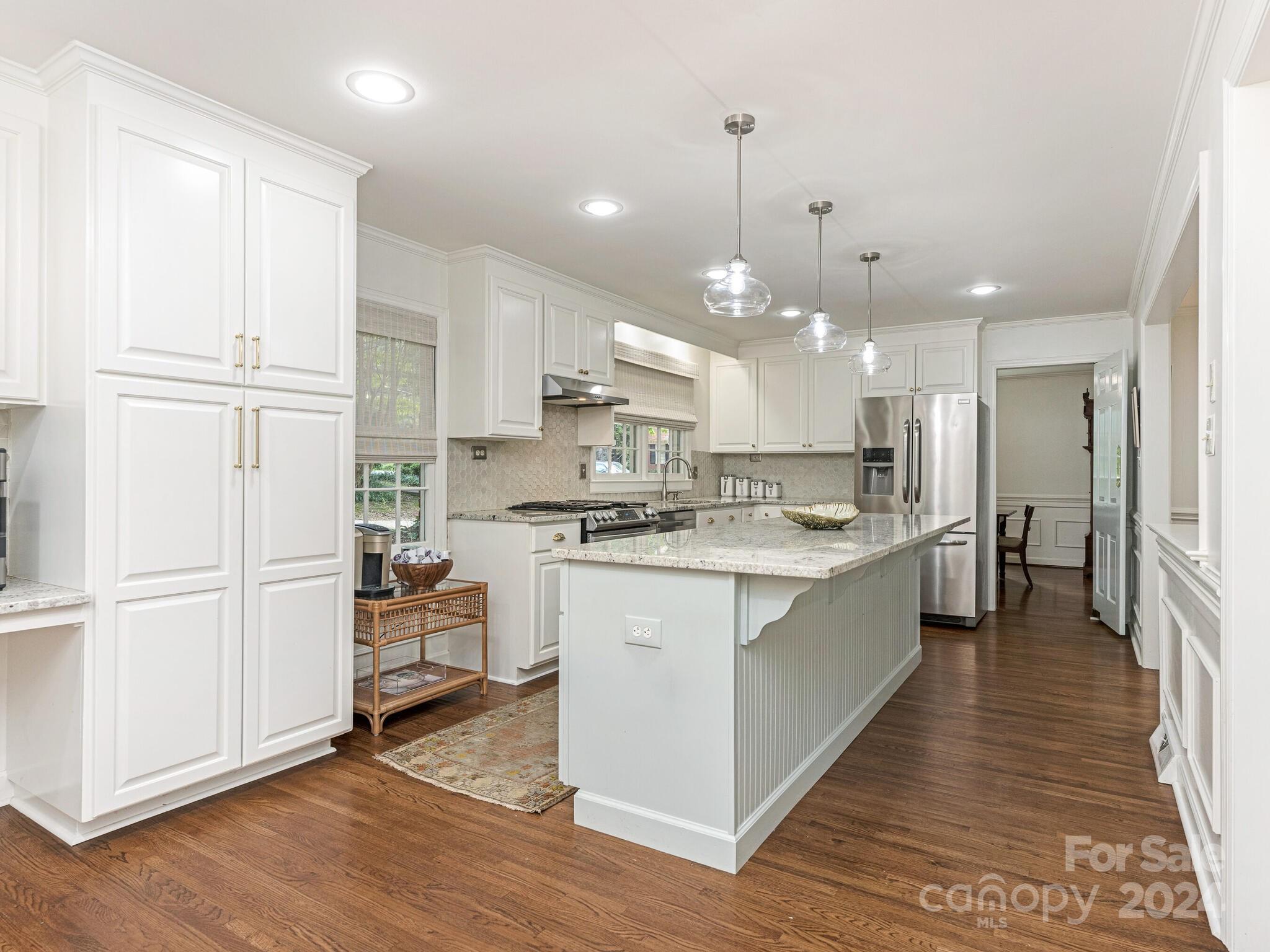 3912 Lovett Circle Charlotte, NC 28210 - Photo 8 of 25 a large kitchen with white cabinets and stainless steel appliances