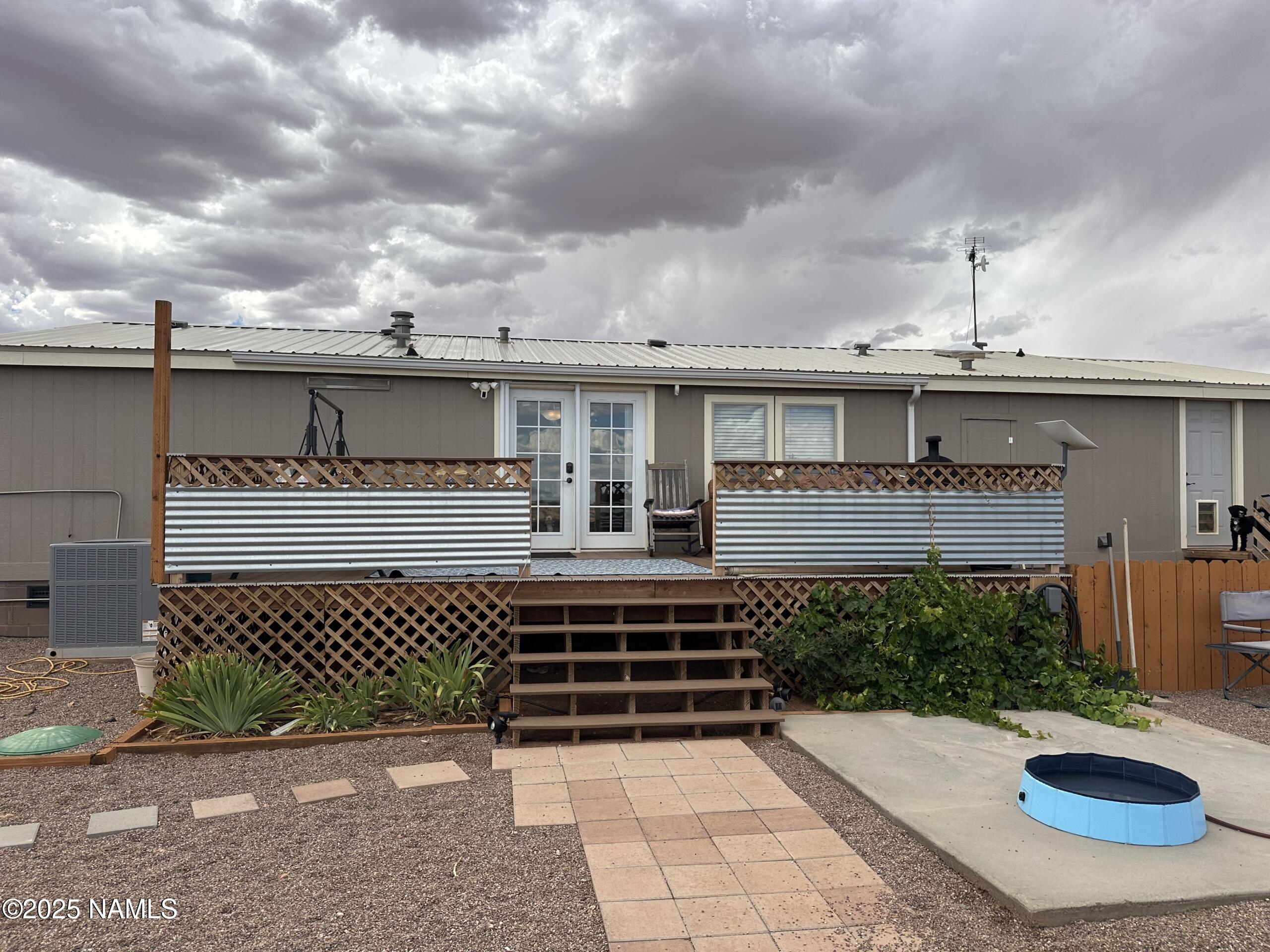 4501 Well Field Road Winslow, AZ 86047 - Photo 12 of 13 a view of a patio with table and chairs and potted plants