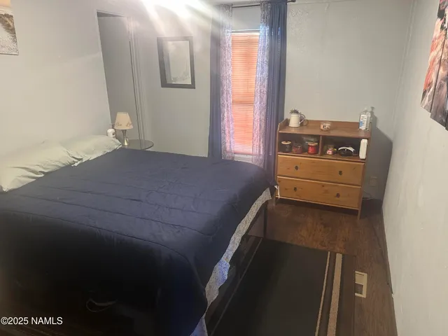 a bedroom with a bed and a mirror
