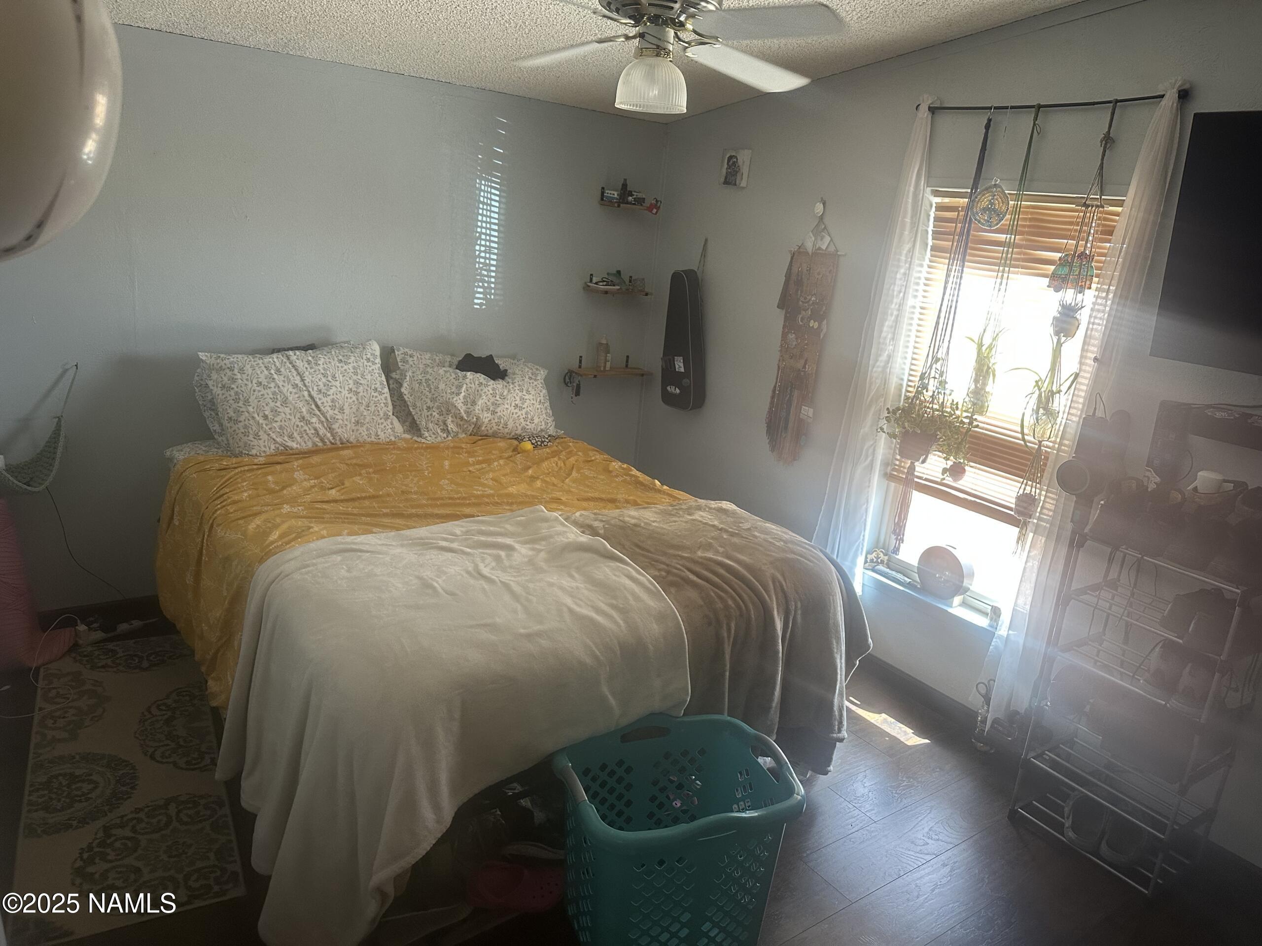 4501 Well Field Road Winslow, AZ 86047 - Photo 5 of 13 a bed sitting in a bedroom next to a window