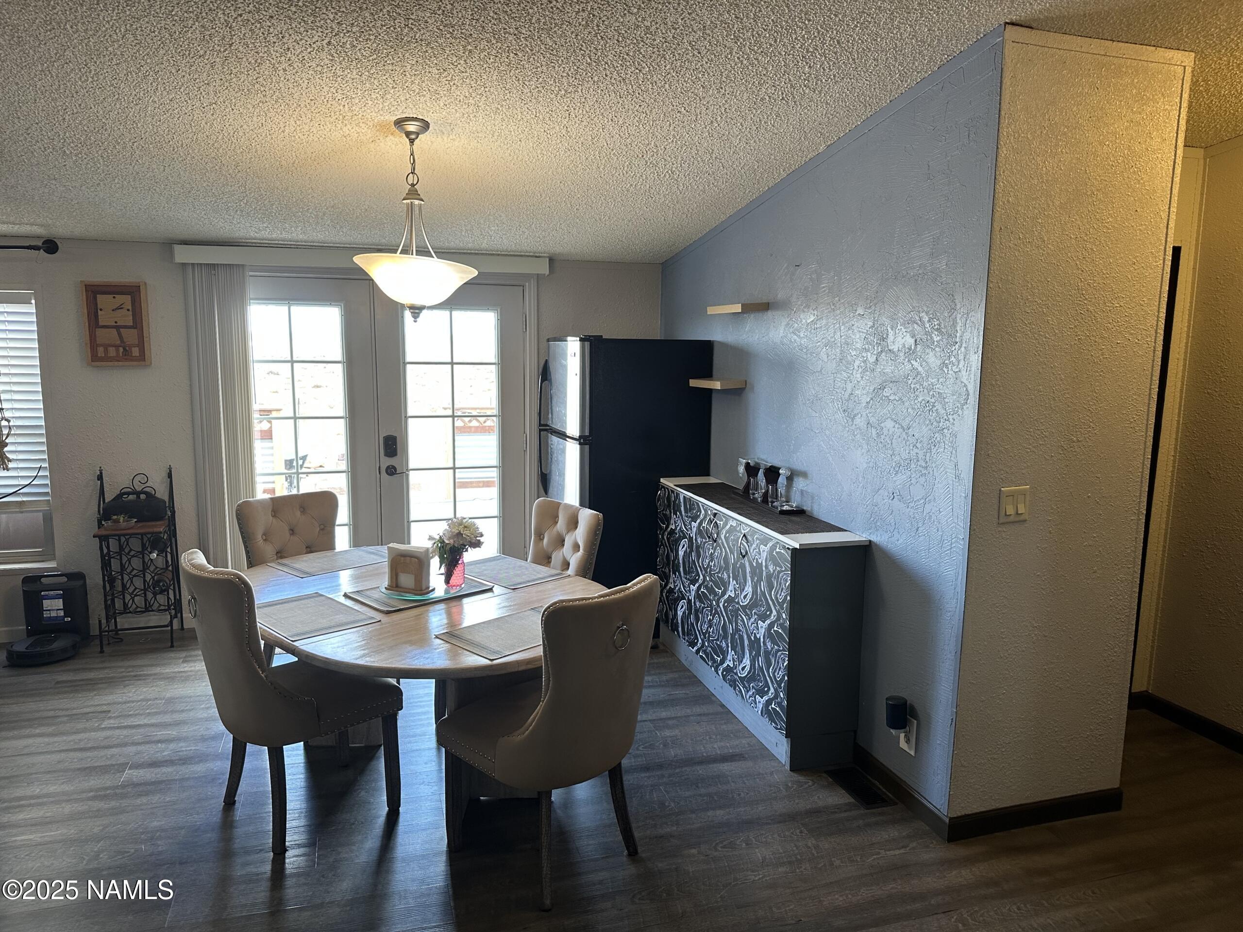 4501 Well Field Road Winslow, AZ 86047 - Photo 8 of 13 a view of a dining room with furniture window and wooden floor