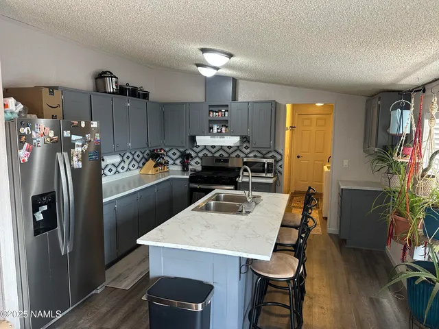 a kitchen with refrigerator and stove