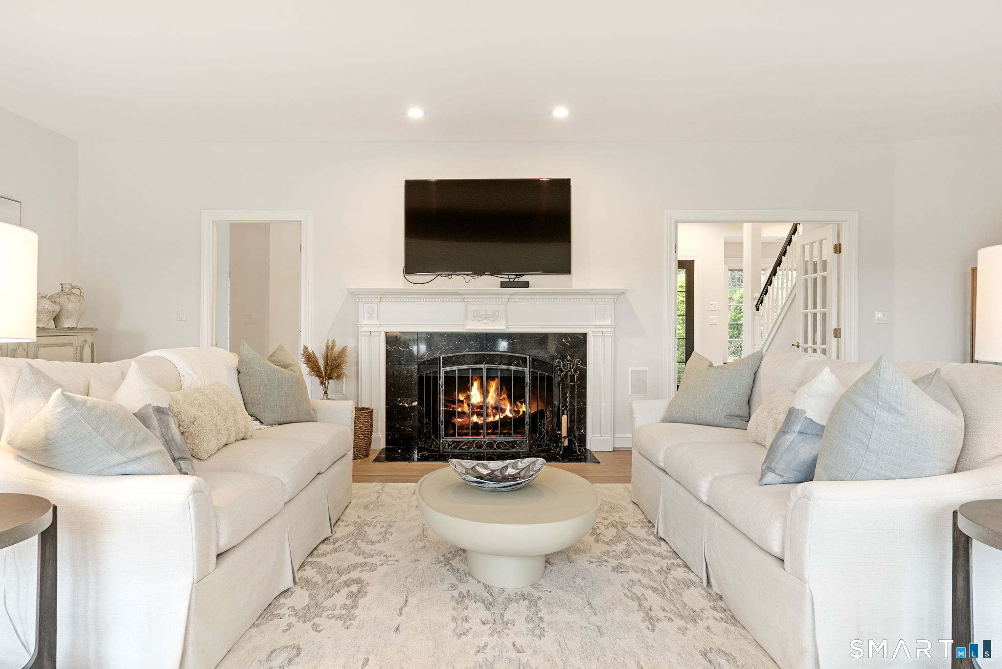 15 Cobtail Way Simsbury, CT 06070 - Photo 3 of 40 a living room with furniture a flat screen tv and a fireplace