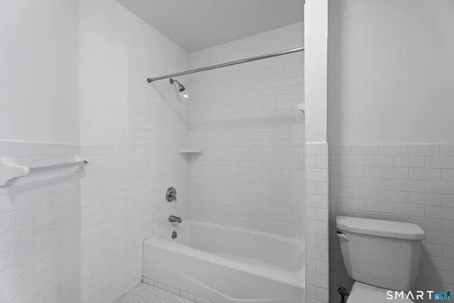 a bathroom with a bathtub and a toilet