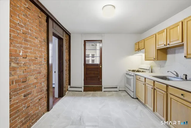 a view of a kitchen with electric appliances