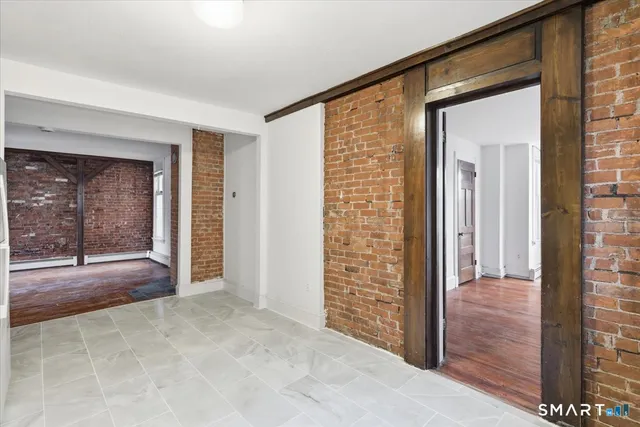 hallway with wooden floor and front door