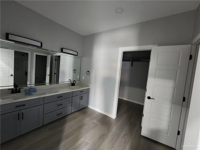 a bathroom with double vanity sink and mirror