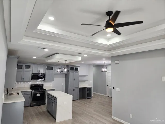 a view of a kitchen and kitchen with stainless steel appliances
