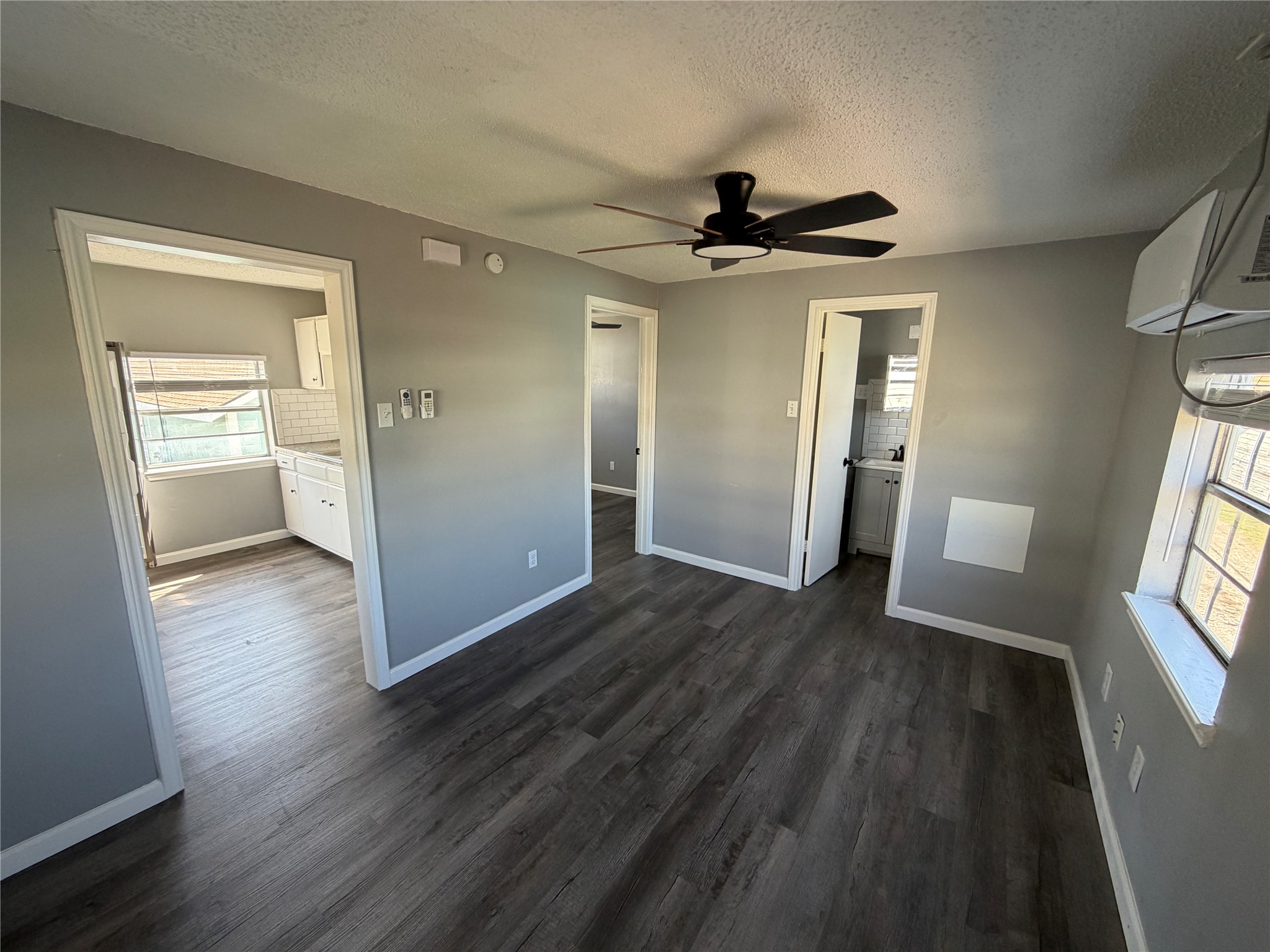 5616 Avenue R, Unit 2 Galveston, TX 77551 - Photo 3 of 8 wooden floor in an empty room with a window