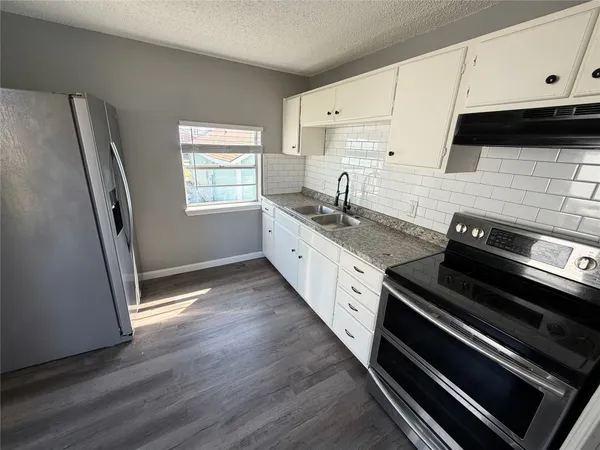 a kitchen with appliances and cabinets