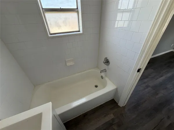 a bathroom with a bathtub and shower