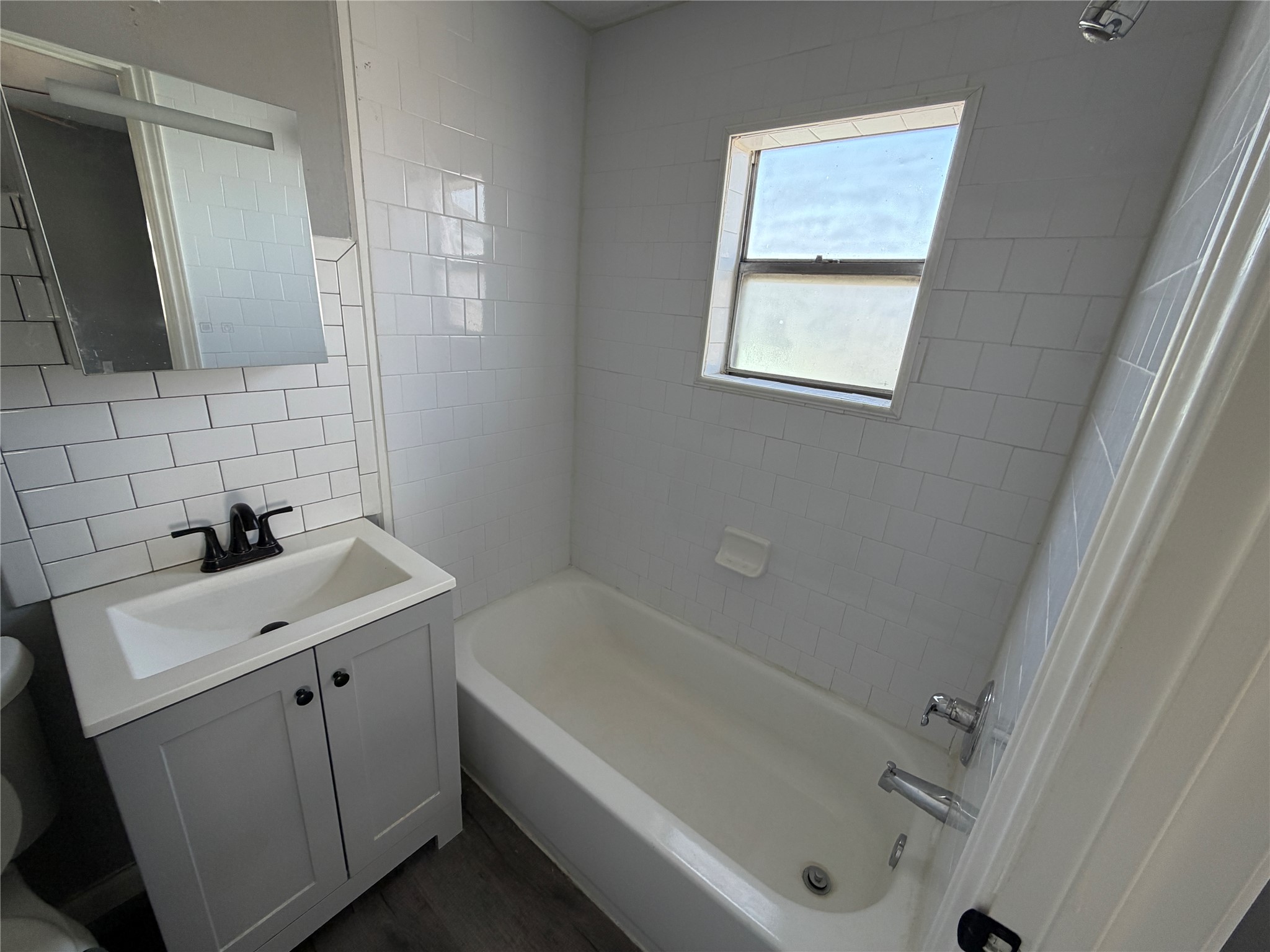 5616 Avenue R, Unit 2 Galveston, TX 77551 - Photo 8 of 8 a bathroom with a sink and a bathtub