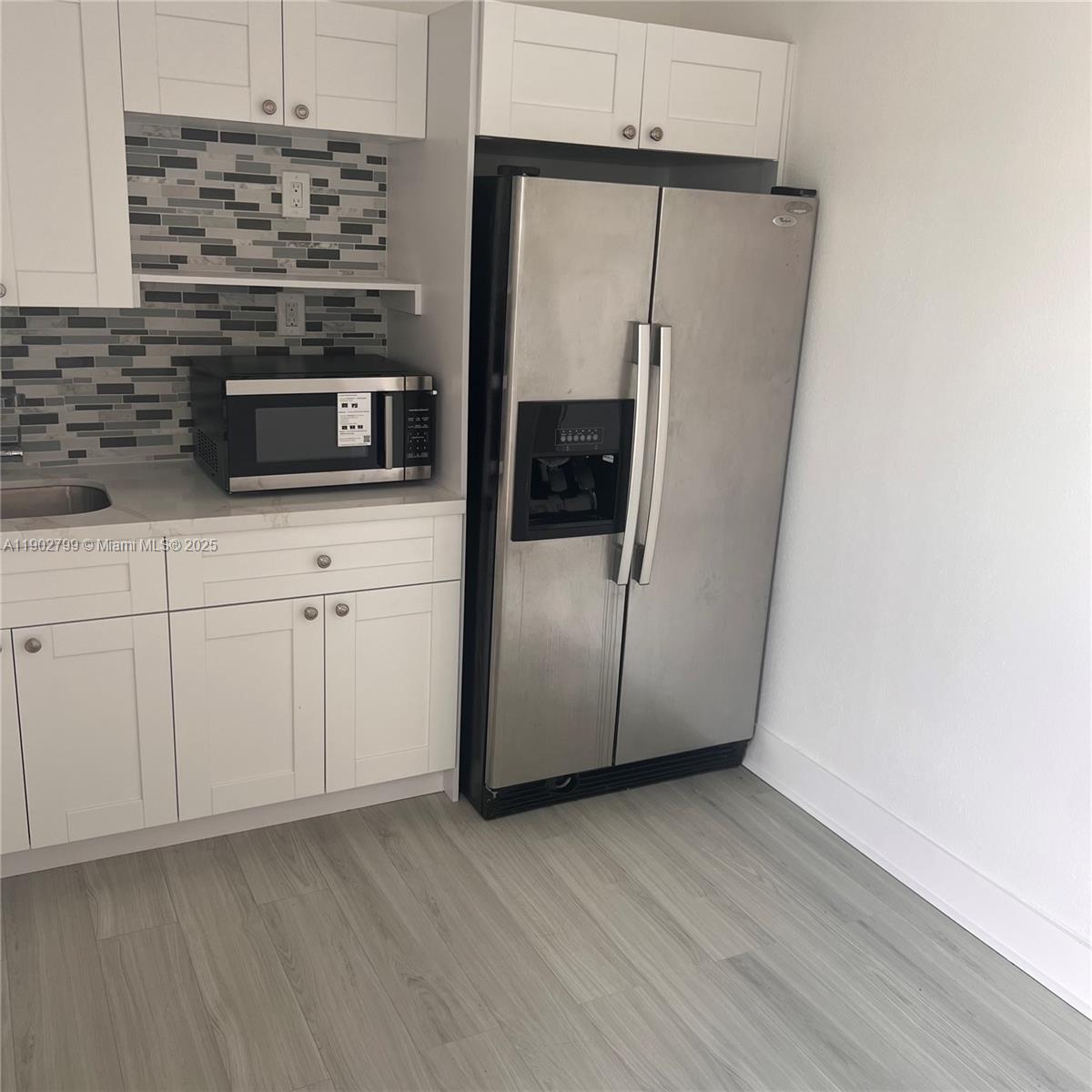 a kitchen with stainless steel appliances a refrigerator and a stove top oven