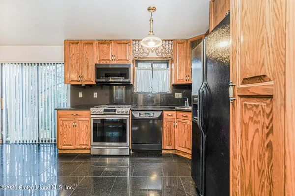 a kitchen with stainless steel appliances granite countertop a stove and a refrigerator