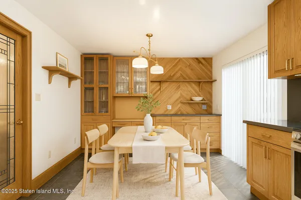 a dining room with furniture and window