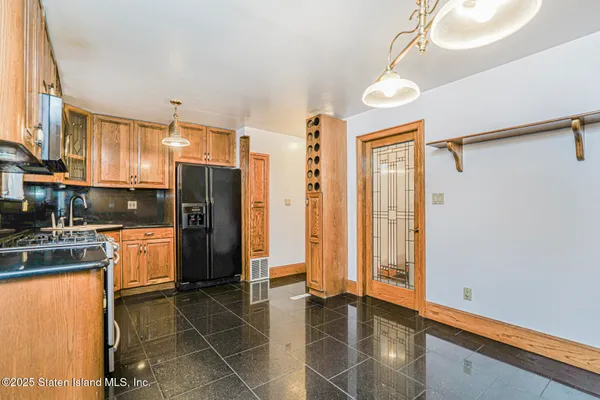 a kitchen with stainless steel appliances a refrigerator and a stove top oven