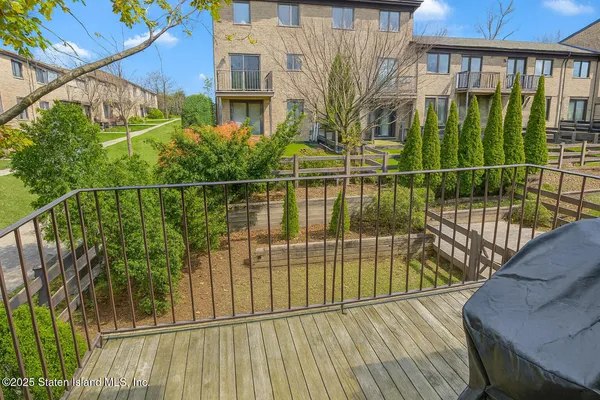 a view of a balcony with a floor to ceiling window next to a yard