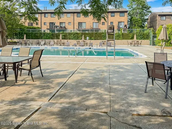 a view of a patio with a table chairs and a backyard