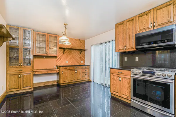 a kitchen with stainless steel appliances a stove a microwave and cabinets