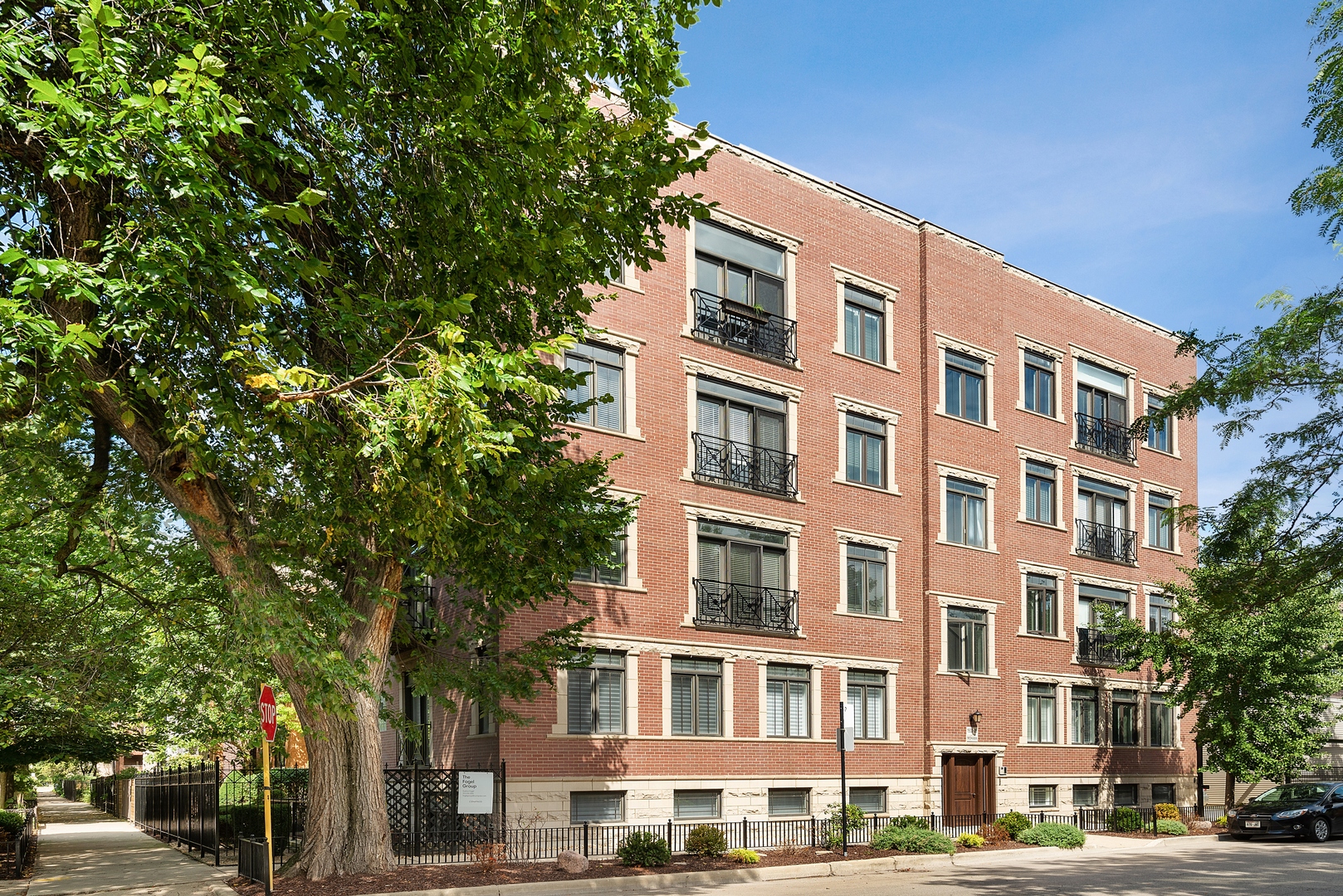 1503 North Mohawk Street, Unit 1E Chicago, IL 60610 - Photo 1 of 25 a front view of a building with lot of trees and plants