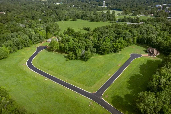 a view of a green field with lawn chairs