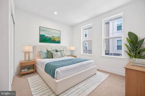 a bedroom with a large bed and a potted plant